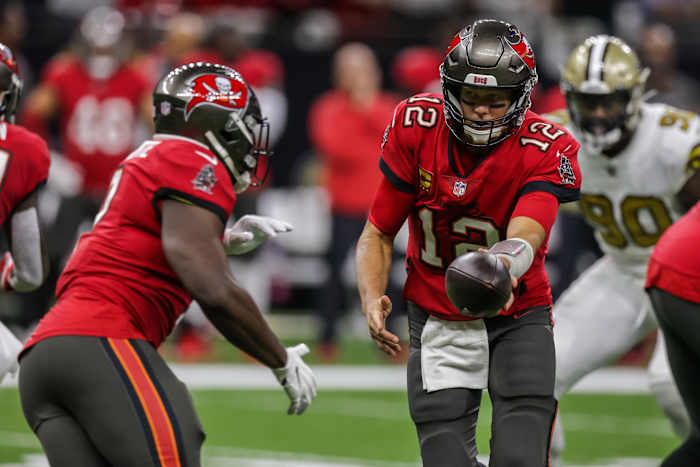 Buccaneers quarterback Tom Brady (12) hands the ball off to Leonard Fournette (7) against New Orleans. Mandatory Credit: Stephen Lew-USA TODAY